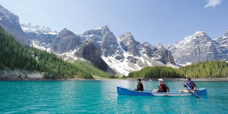 Three tourists canoe across