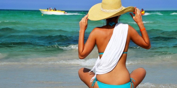 Woman sitting on beach in