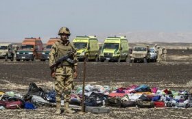 A soldier guards the belongings of victims of the airplane crash