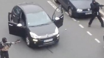 video clip of 2 gunman mixed up in Charlie Hebdo shooting walking to a police man and shooting him.